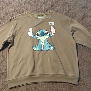 a brown sweatshirt with stitch on it